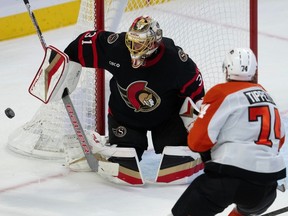 Senators goaltender Anton Forsberg keeps his eye on the puck after turning aside a shot by the Flyers' Owen Tippett in the second period on Saturday afternoon.