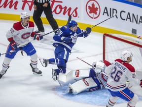 Toronto Maple Leafs’ Fraser Minten goes hard to the net in front of Montreal Canadiens goalie Jake Allen in the season opener.