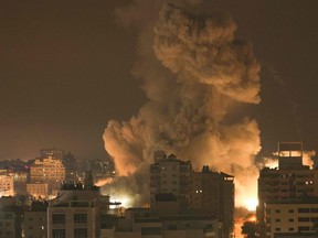 Fire and smoke rise above buildings in Gaza City during an Israeli air strike on Oct. 8, 2023.