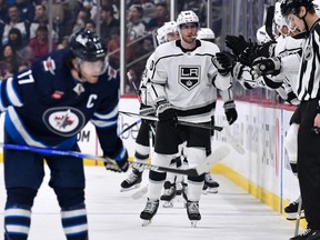 Los Angeles Kings' Pierre-Luc Dubois (80) celebrates his goal against the Winnipeg Jets with teammates as Winnipeg Jets centre Adam Lowry (17) looks on during the second period NHL action in Winnipeg on Tuesday October 17, 2023.
