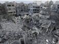 Palestinians inspect the rubble of the Yassin Mosque destroyed after it was hit by an Israeli airstrike at Shati refugee camp in Gaza City, early Monday, Oct. 9, 2023.