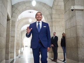 Manitoba's new premier, Wab Kinew, is scheduled to be sworn in today and appoint his cabinet. Kinew walks to the premier's office in Winnipeg, Thursday, Oct. 5, 2023.