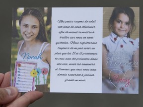 A card distributed by the family depicts Romy, right, and Norah Carpentier, at a funeral home in Levis, Que., Monday, July 20, 2020. A coroner investigating the deaths of two Quebec girls who were killed by their father in July 2020 has described the police response in the case as "too little, too late."