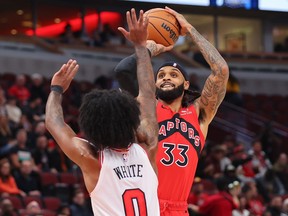Gary Trent Jr. of the Toronto Raptors shoots over Coby White of the Chicago Bulls at the United Center on October 17, 2023 in Chicago.