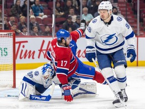 Canadiens' Josh Anderson falls over Lightning goalie Matt Tomkins after check by defenceman Mikhail Sergachev, right, during game at the Bell Centre earlier this month. Anderson has yet to score this season.