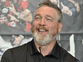 Quebec Remparts general manager and coach Patrick Roy reacts at a news conference as he announces his retirement from junior hockey.