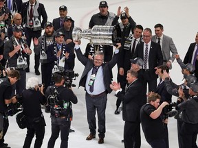 LAS VEGAS, NEVADA - JUNE 13: General manager Kelly McCrimmon of the Vegas Golden Knights hoists the Stanley Cup after the team's 9-3 victory over the Florida Panthers in Game Five of the 2023 NHL Stanley Cup Final at T-Mobile Arena on June 13, 2023 in Las Vegas, Nevada. The Golden Knights won the series four games to one.