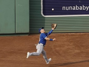 Daulton Varsho of the Toronto Blue Jays tracks down a long fly ball in center field off the bat of Connor Wong #12 of the Boston Red Sox during the fifth inning at Fenway Park on August 5, 2023 in Boston, Massachusetts.