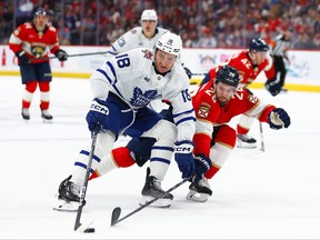 Noah Gregor (18) of the Toronto Maple Leafs and Uvis Balinskis (26) of the Florida Panthers battle for the puck during the second period of their NHL game at Amerant Bank Arena on Thursday, Oct. 19, 2023, in Sunrise, Fla.