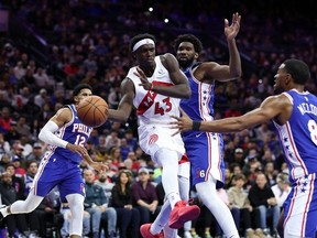 Pascal Siakam of the Toronto Raptors drives between Joel Embiid and De'Anthony Melton #8 of the Philadelphia 76ers during the second quarter at the Wells Fargo Center on November 02, 2023 in Philadelphia, Pennsylvania.