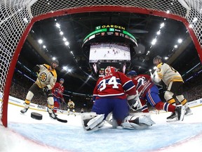 The puck is fired past Canadiens goalie Jake Allen during Saturday's 5-2 loss in Boston.