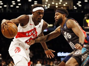 Pascal Siakam (43) of the Toronto Raptors dribbles against Royce O'Neale (00) of the Brooklyn Nets during the first half of an NBA In-Season Tournament game at Barclays Center on Tuesday, Nov. 28, 2023, in Brooklyn, N.Y.