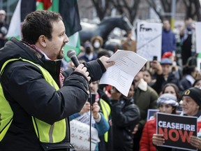 Wesam Cooley, who also goes by Wesam Khaled, who was recently arrested and charged by the Calgary police, addresses a pro-Palestinian rally in Calgary, Alta., Sunday, Nov. 19, 2023.