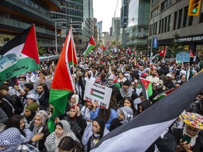 A pro-Palestinian march makes its way north along Bay St. in downtown Toronto on Monday, Oct. 9, 2023. Roads in downtown Toronto were closed late on Tuesday, Oct. 17, 2023, after another pro-Palestinian rally at Bloor and Yonge Sts., while a pro-Israeli rally was being held at the University of Toronto.