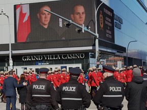 Police and peace officers march down 104 Avenue and up 102 Street into Rogers Place on March 27, 2023. The regimental funeral was for Edmonton Police Service constables Travis Jordan and Brett Ryan who were killed in the line of duty.