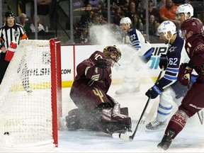 Winnipeg Jets' Nino Niederreiter scores a goal against Arizona Coyotes goaltender Karel Vejmelka as Coyotes' Troy Stecher, and Jets' Ville Heinola, and Mason Appleton all look on during the second period on Saturday, Nov. 4, 2023, in Tempe, Ariz.