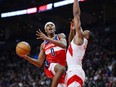 Washington Wizards guard Bilal Coulibaly (0) goes up for a lay up while defended by Toronto Raptors forward Scottie Barnes (4) during first half in Toronto on Monday.