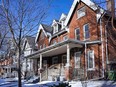 A row of old semi-detached houses in winter.