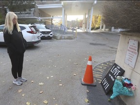 A day after a car attack killed a woman, 61, and hurt two other people at an apartment complex on Cassandra Blvd. in North York, Lesley Halls (pictured) visits a makeshift memorial on Thursday, Nov. 16, 2023.