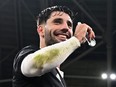 Hungary's midfielder and captain Dominik Szoboszlai (C) drinks a palinka, a drink gifted by Hungarian fans and spectators, as he celebrates the team's qualification for the UEFA Euro 2024 after their football match against Montenegro on November 19, 2023. Hungary won 3-1 and qualified for next year's European Championship.