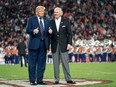 Former U.S. President Donald Trump, left, joins South Carolina Gov. Henry McMaster on the field during halftime in the Palmetto Bowl between Clemson and South Carolina at Williams Brice Stadium in Columbia, S.C., Saturday, Nov. 25, 2023.