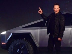 Tesla co-founder and CEO Elon Musk gestures while introducing the all-electric battery-powered Tesla Cybertruck at Tesla Design Center in Hawthorne, Calif., Nov. 21, 2019.