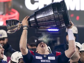 Montreal Alouettes quarterback Cody Fajardo hoists the Grey Cup as the Alouettes celebrate defeating the Winnipeg Blue Bombers in the 110th Grey Cup in Hamilton on Sunday, Nov. 19, 2023.