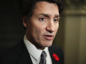 Prime Minister Justin Trudeau speaks to reporters as he arrives to a caucus meeting in Ottawa on Wednesday, Nov. 8, 2023.