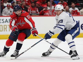 Trevor van Riemsdyk of the Washington Capitals and Matthew Knies of the Toronto Maple Leafs battle for the puck at Capital One Arena on October 24, 2023 in Washington.
