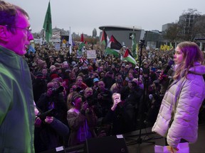 Greta Thunberg, right, is interrupted by a climate activist, left, after Thunberg expressed solidarity with the Palestinians as tens of thousands of people marched through Amsterdam, Netherlands, Sunday, Nov. 12, 2023, to call for more action to tackle climate change.