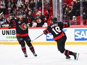 Tim Stutzle of the Senators celebrates after scoring a highlight-reel goal to win Thursday's game against the Red Wings in overtime. At left is Senators defenceman Jake Sanderson. TSN has included the pair on this year's list of the top 10 under-24 players.