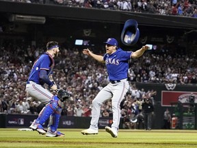 Texas Rangers catcher Jonah Heim, left, and relief pitcher Josh Sborz celebrate after Game 5 of the baseball World Series against the Arizona Diamondbacks Wednesday, Nov. 1, 2023, in Phoenix. The Rangers won 5-0 to win the series 4-1.