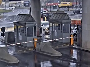 In this photo taken from security video, a light colored vehicle, top left, travels toward the Rainbow Bridge customs plaza, Wednesday, Nov. 22, 2023, in Niagara Falls, N.Y.