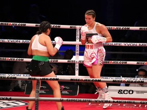 Jeanette Guadeloupe Zacarias Zapata (left) faces Marie-Pier Houle in a welterweight fight at the stade IGA, Montréal, Saturday, Aug. 28, 2021. A Quebec coroner says Mexican boxer Zapata did not disclose a likely prior concussion before the August 2021 match in Montreal that led to her death.