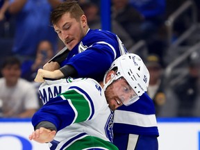 Vancouver Canucks' Mark Friedman and Calvin de Haan of the Lightning fight during a game at Amalie Arena on Oct. 19, 2023 in Tampa.