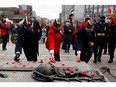 Veterans lay poppies on the tomb of the Unknown Soldier during a ceremony at the National War Memorial on Remembrance Day in Ottawa, Nov. 11, 2021.