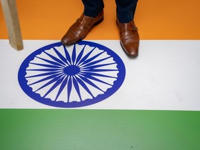 A protester stands on the Indian flag outside of the Consulate General of India office during a protest in Vancouver on Saturday, June 24, 2023. Business leaders continue to fret over the economic uncertainty fostered by the rift between the Canadian and Indian governments, saying the ongoing suspension of free trade talks hurts both sides.