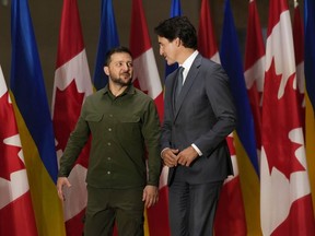 Ukrainian President Volodymyr Zelenskyy, left, and Prime Minister Justin Trudeau talk before a joint press conference on Parliament Hill in Ottawa on Friday, Sept. 22, 2023.