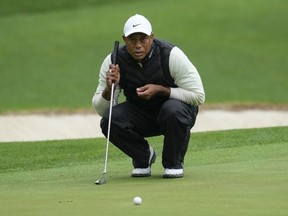 Tiger Woods lines up a putt on the 16th hole during the weather delayed second round of the Masters golf tournament at Augusta National Golf Club Saturday, April 8, 2023, in Augusta, Ga.