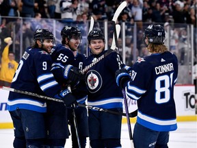 Winnipeg Jets' Cole Perfetti (91) celebrates his goal against the New Jersey Devils with Alex Iafallo (9), Mark Scheifele (55) and Kyle Connor (81) during the second period of NHL action in Winnipeg on Tuesday November 14, 2023.