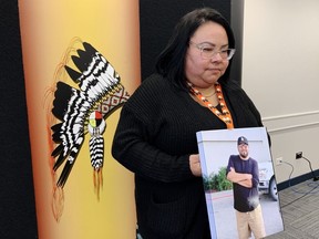 Jody Beardy holds a photo of her partner, Elias Whitehead, during a press conference in Winnipeg on Thursday, Nov. 2, 2023. Whitehead died while being taken into police custody in Winnipeg on Oct. 15.