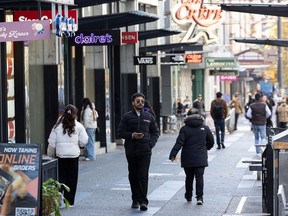 People go about their business on Granville Street in Vancouver on Nov. 7. Many business owners are experiencing more theft and crime, and are worried about their employees.