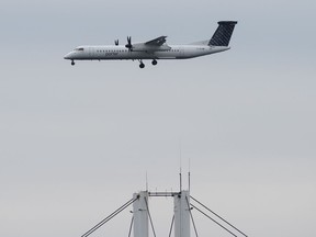 A Porter airplane lands in Toronto on Wednesday, March 18, 2020.
