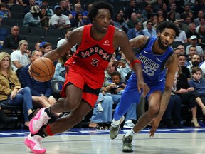 O.G. Anunoby of the Raptors drives the ball past Derrick Jones Jr. of the Dallas Mavericks at American Airlines Center on November 8, 2023 in Dallas.