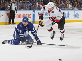 Ottawa Senators' Tim Stuzle jumps over the stick of Maple Leafs' Matthew Knies at Scotiabank Arena on Wednesday, Nov. 8, 2023 in Toronto.