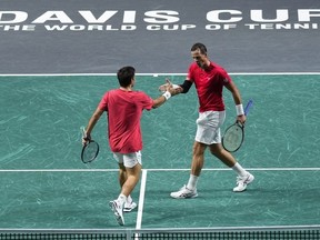 Canada's Vasek Pospisil, right, and Canada's Alexis Galarneau react after winning a point against Finland's Harri Heliovaara and Finland's Patrik Niklas-Salminen during a Davis Cup quarterfinal tennis match between Canada and Finland in Malaga, Spain, Tuesday, Nov. 21, 2023.