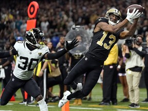 New Orleans Saints wide receiver Michael Thomas makes a catch in front of Jacksonville Jaguars cornerback Montaric Brown in New Orleans, Thursday, Oct. 19, 2023.