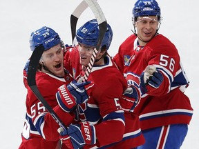 Canadiens Justin Barron, centre, is congratulated by teammates Michael Pezzetta, left, and Jesse Ylonen afer scoring against the Devils in October. It was one of five goals Barron had scored this year heading into Monday night's action.