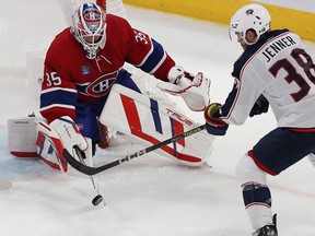 Canadiens goaltender Sam Montembeault keeps his eye on the puck with Blue Jackets' Boone Jenner lurking during a agme at the Bell Centre in October.