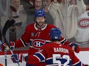 Montreal Canadiens' Josh Anderson (17) celebrates his empty-net goal with teammate Justin Barron (52) during third-period NHL action in Montreal on Monday Dec. 4, 2023.
